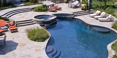 Custom Shape Swimming Pool With Built-In Spa & Stone Pool Deck