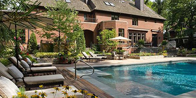 Custom Swimming Pool with stone, paver, & wood pool deck