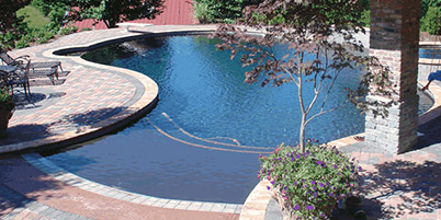 Custom designed zero-entry pool with paver pool deck.