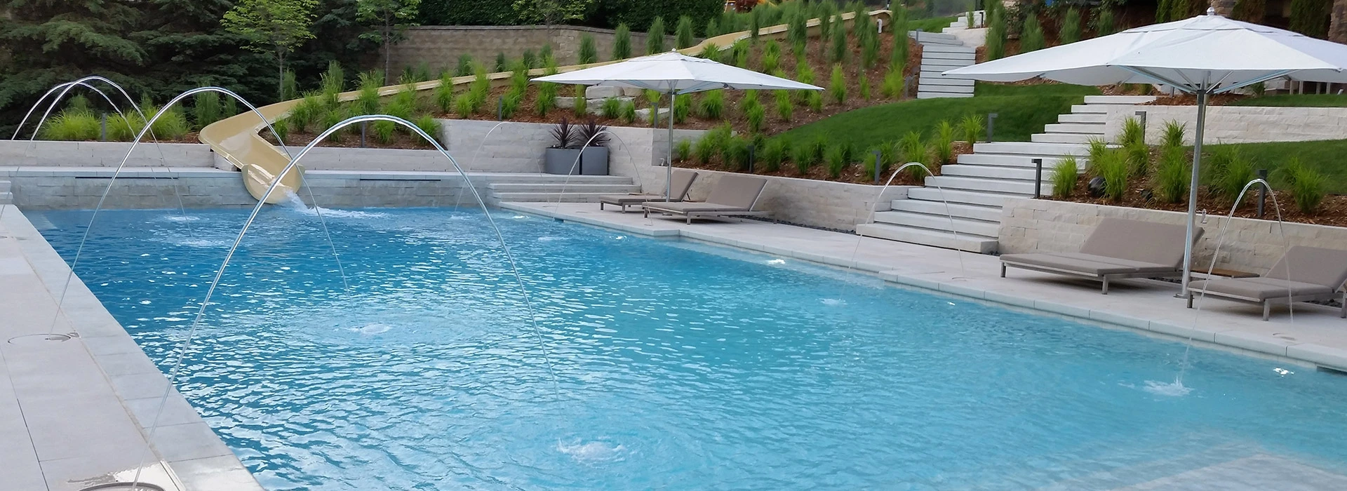 In-ground Concrete Pool With Built-in Slide Using the Natural Slope of the Landscape