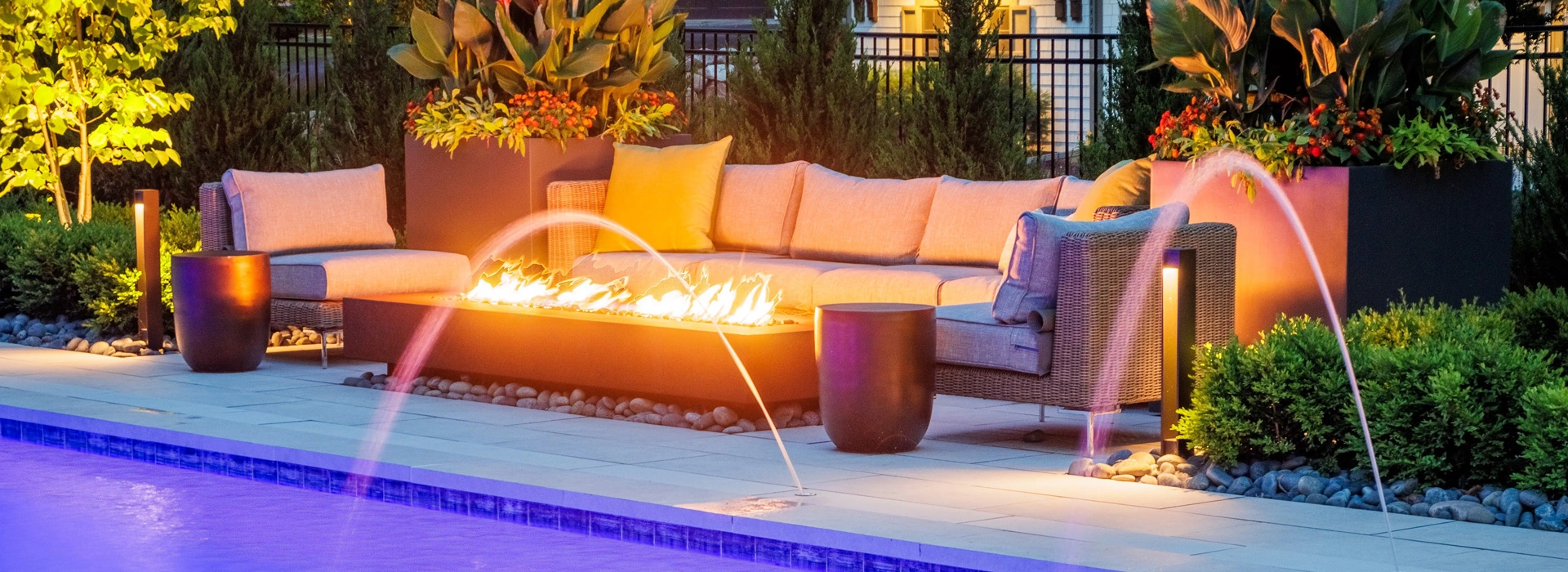 Fireplace By The Pool with Cushioned Sofa Seating in the Twin Cities