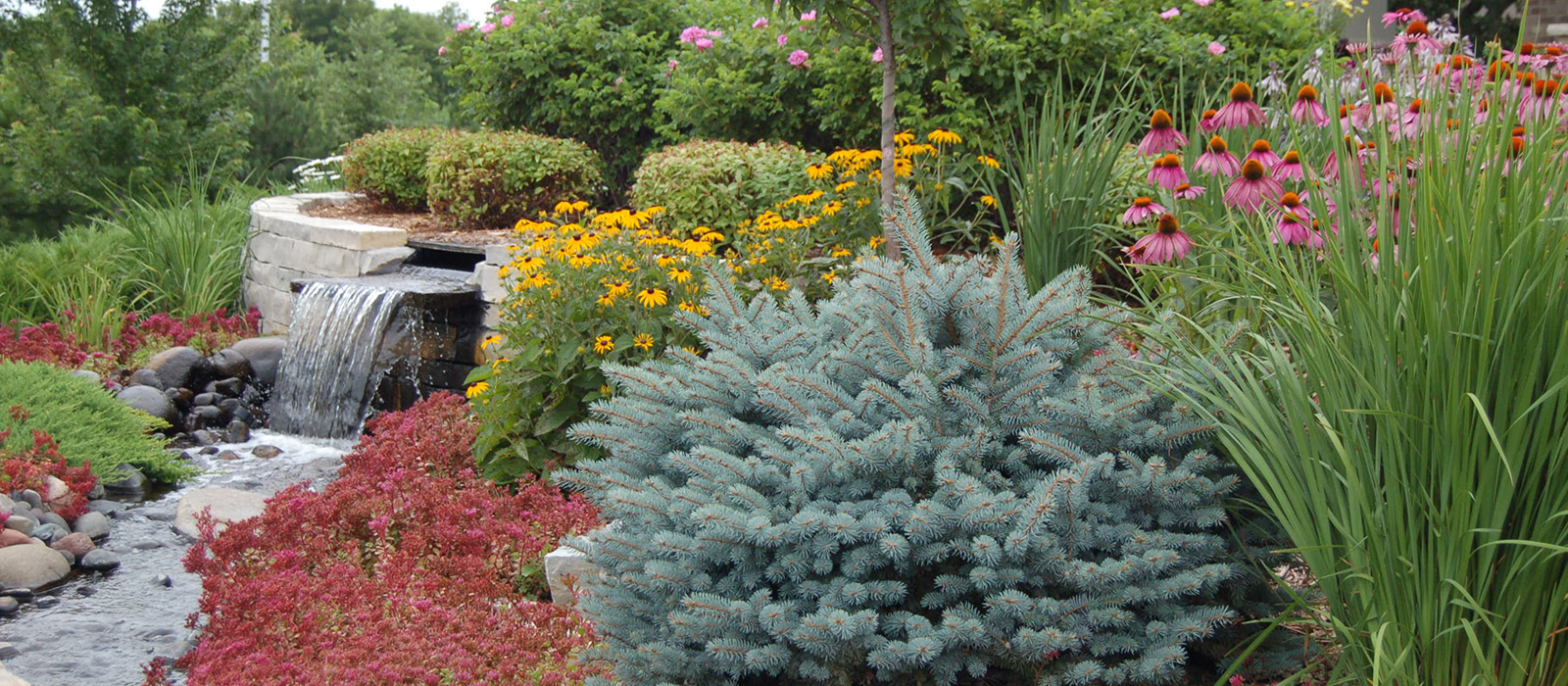 Softscape Landscaping With Stone Waterfall Feature