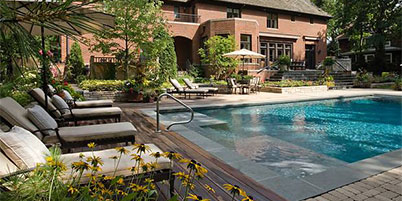 Luxurious Swimming Pool With Paver, Stone & Wood Decking.