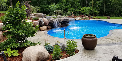 Swimming Pool With A Custom Shape Fed By A Waterfall.